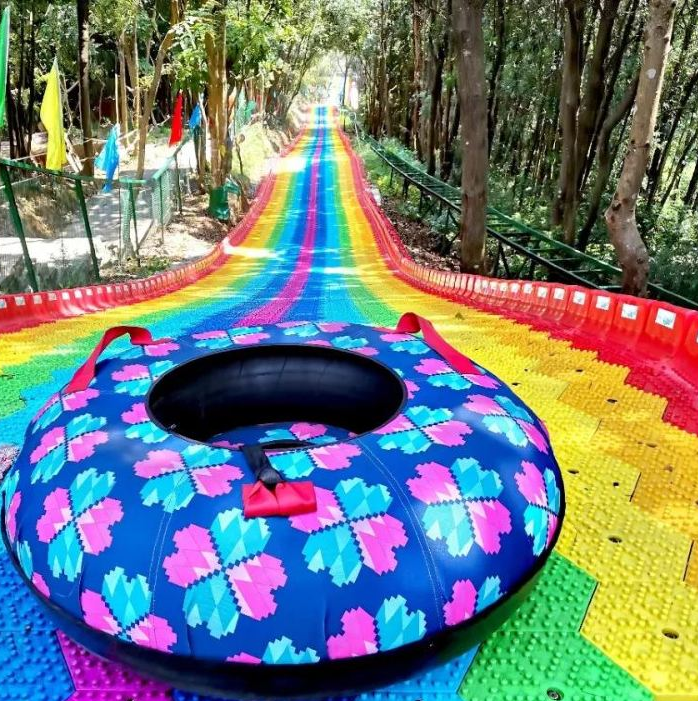 What staff members are required for a rainbow slide facility?